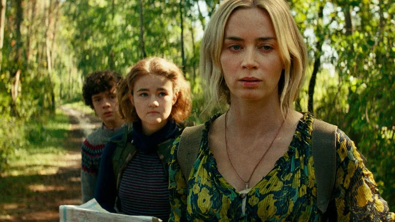 A shot from “Quiet Place. Part II” with the main characters going through a forest.